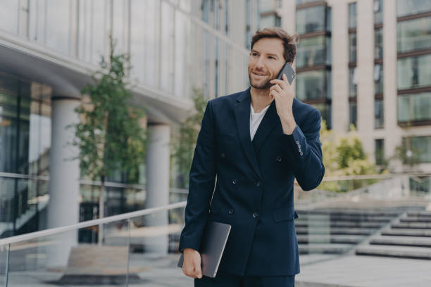 istock Handsome unshaven male entrepreneur communicates distantly with colleagues or partner 1415398652