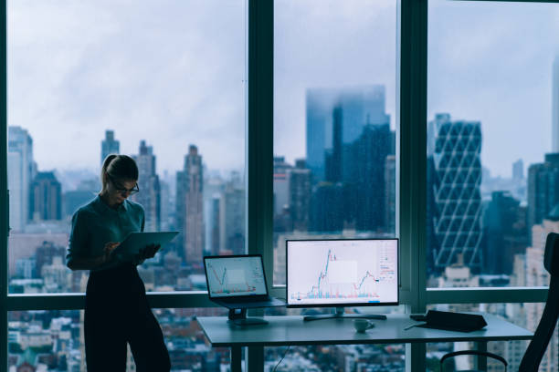 istock Thoughtful woman working on tablet in office 1415399571