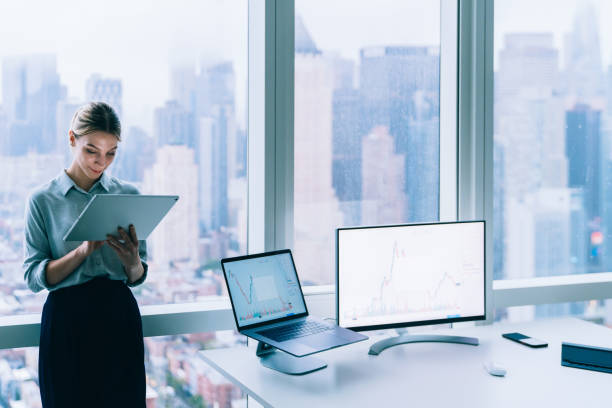 istock Focused businesswoman checking information on tablet 1415399575