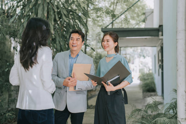 istock 3 asian chinese lecturers discussion outside college building during break time 1415402793