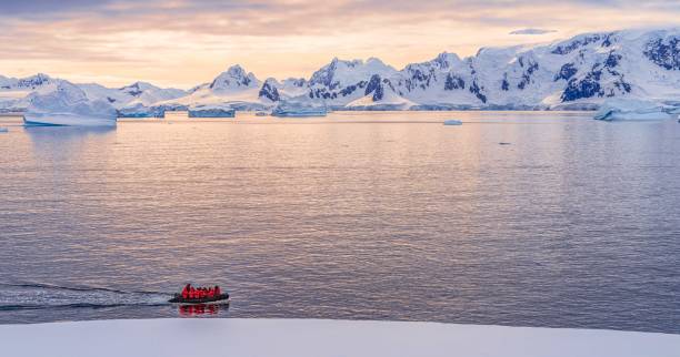 Expeditions - Zodiac cruises through Antarctic iceberg landscape at Portal Point which is located at the entrance to Charlotte Bay on the Reclus Peninsula, on the west coast of Graham Land. stock photo