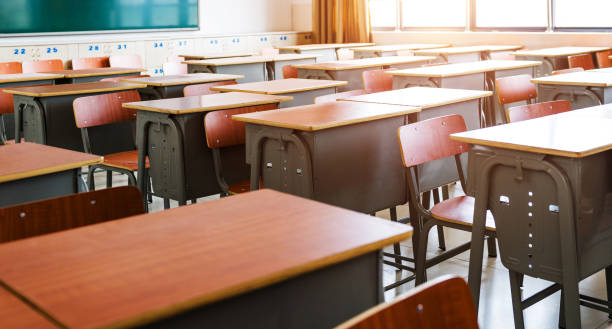 istock Empty classroom with desks, chairs and chalkboard 1415405958