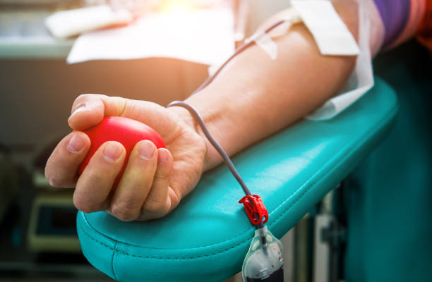 Blood donor at donation with bouncy ball holding in hand stock photo