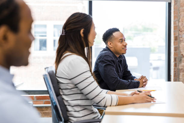 istock Diverse business people interact with unseen presenter 1415407805