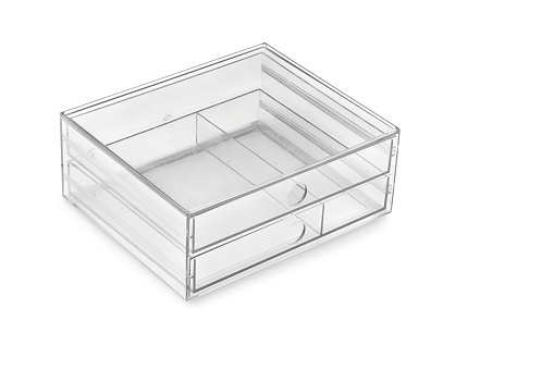 Empty clear acrylic box with drawers on white background.