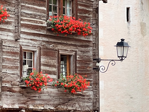 Mountain village house and a street lamp, seen in Vals, Graubunden