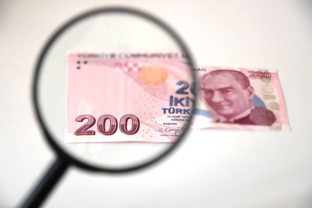 istock Banknotes spread out on a table with a calculator and a magnifying glass. 1415409043