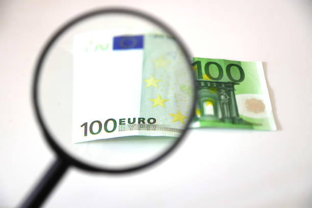 istock Banknotes spread out on a table with a calculator and a magnifying glass. 1415409067