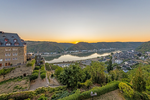 Drone panorama over St. Goar and St. Goarshausen during sunrise in summer
