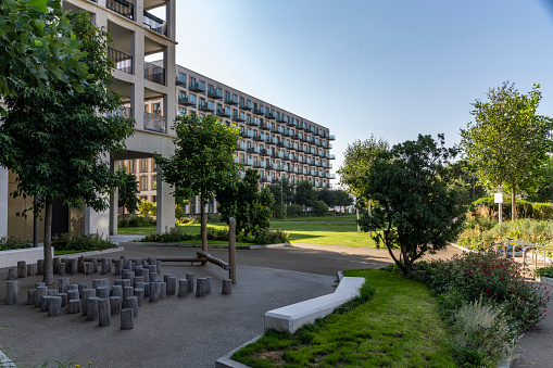 Green courtyard between modern apartment buildings.