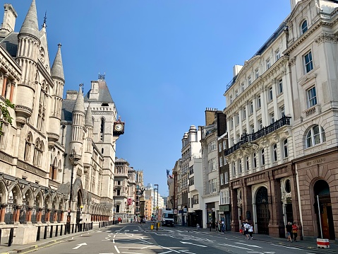 Street scene of Fleet Street by the Courts of Justice in London. London, England, UK. Royal Courts of Justice. The view of The Royal Courts of Justice from Strand. Street view.