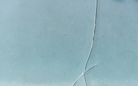 Cracks on glass Thick and opaque glass cracks in vertical, horizontal and oblique lines on the glass surface.