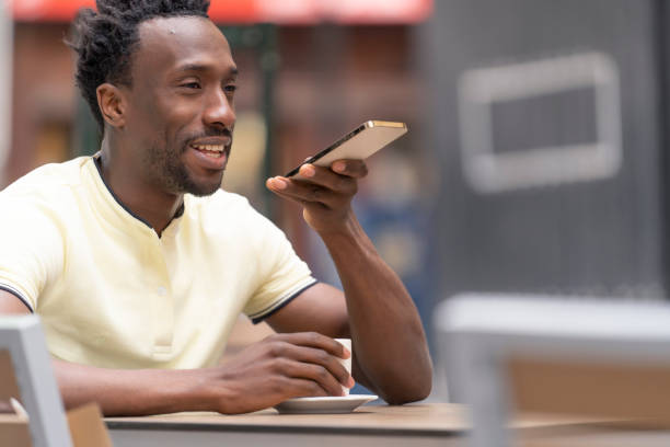 istock African man on a bar terrace making a call with a mobile cell phone 1415416949