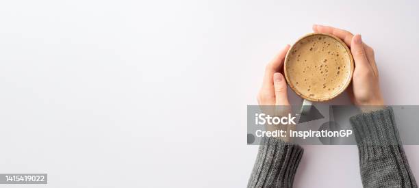 Autumn Mood Concept Panoramic First Person Top View Photo Of Girls Hands In Grey Pullover Holding Mug Of Frothy Coffee On Isolated White Background With Copyspace Stock Photo - Download Image Now