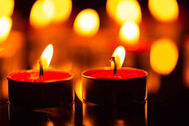 istock macro candle,Burning candles on dark background 1415422343