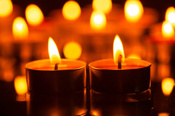 istock macro candle,Burning candles on dark background 1415422454