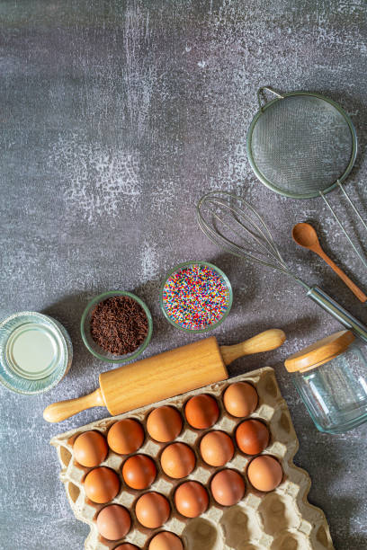 istock bread making equipment,Flour and ingredients on black table,Ingredients for cooking baking, baking background. Flour, sugar, eggs, spices and utensil on black background top view with copy space. 1415422503