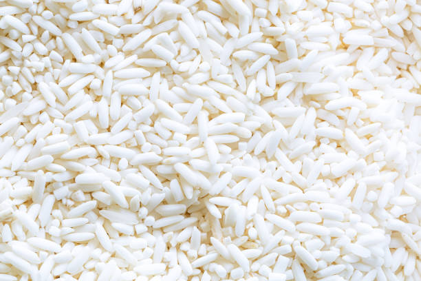 istock macro rice background,organic white raw jasmine, sticky rice background, white long seeds. macro closeup. as picture backdrop or background pattern texture 1415422538