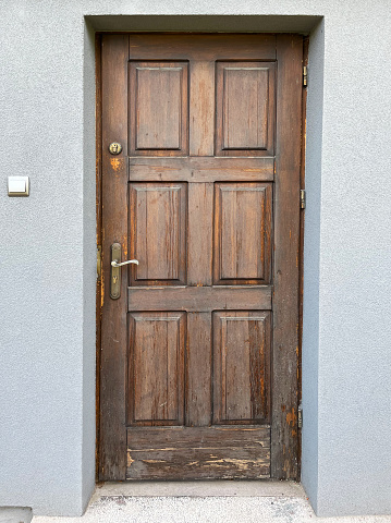 Old entrance door made of wood close-up.
