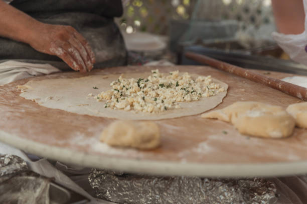 Woman filling Turkish flatbread Gozleme