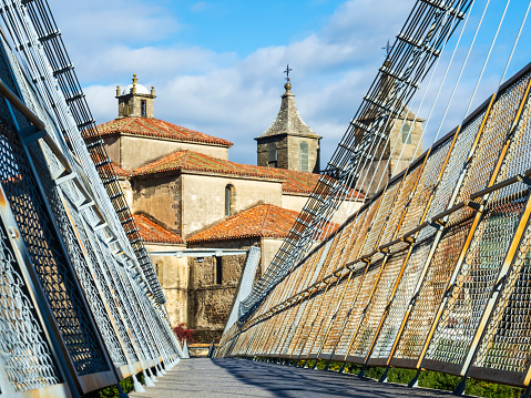 Panoramic view of the Collegiate Church of Santa María Magdalena from the suspension bridge of the city of Cangas de Narcea