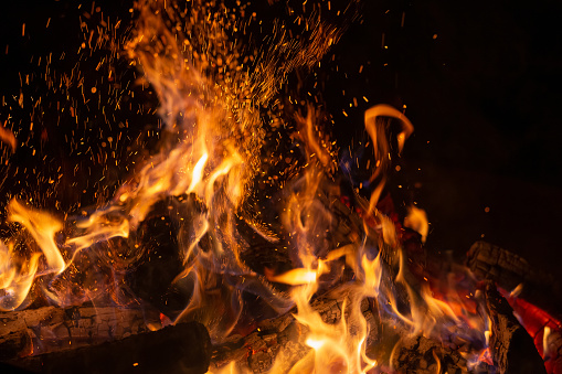 Hot fireplace full of wood and fire burning, closeup