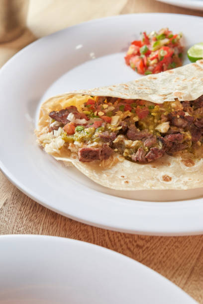 istock Mexican taco with salsa and a variety of toppings 1415436622