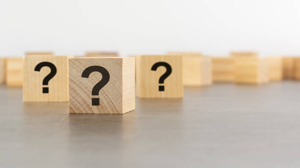 istock front view on many wood cubes with question marks. many question arising concept 1415438829
