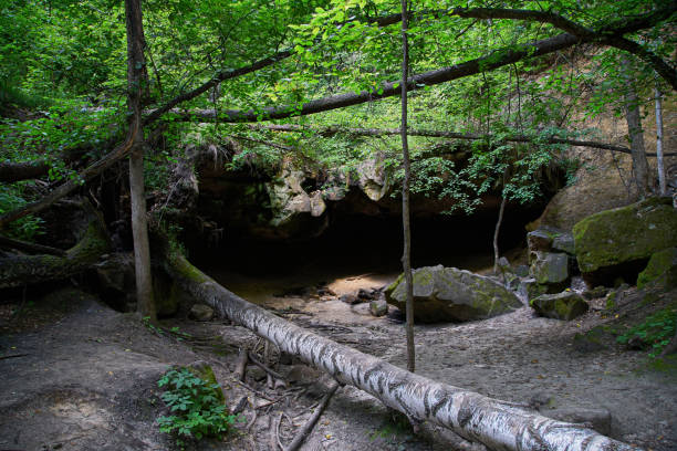 istock A small grotto, a gorge in the forest. Natural background. 1415441615