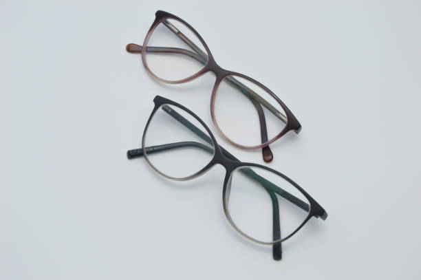 istock Glasses for vision correction in a dark frame lie on a light background. 1415441810