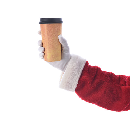 Santa Claus hand and arm holiding a disposabel cup of Coffee over white.