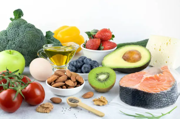 Keto diet: green vegetables, salmon, meat, eggs, berries, fruits, nuts, butter. Foods rich in healthy fats, omega 3. Low-carb diet.