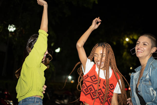 istock Female friends having fun at city by night 1415444064