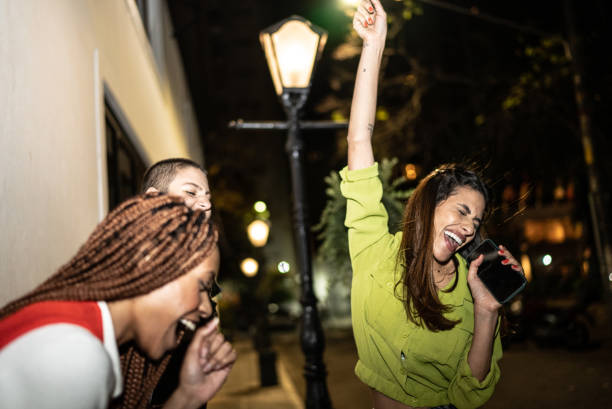 istock Female friends having fun at city by night 1415444111