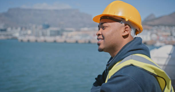istock Logistics, delivery or shipping engineer looking motivated and thinking or planning vision for ocean or sea cargo dock. Successful mechanical technician with a building idea for import or export port 1415444220