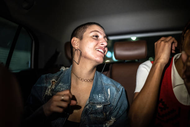 istock Friends talking and laughing in the car 1415444403