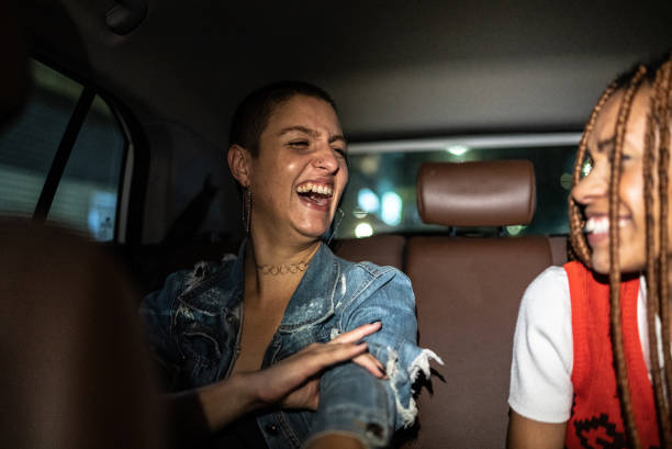 istock Friends talking and laughing in the car 1415444422