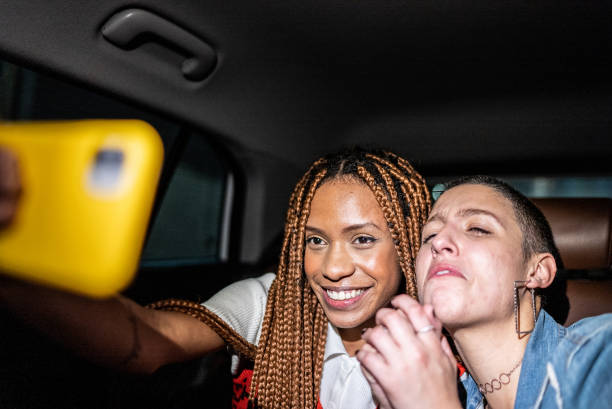 istock Friends filming using mobile phone in the car 1415444446