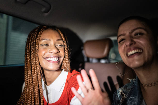 istock Friends talking and laughing in the car 1415444447