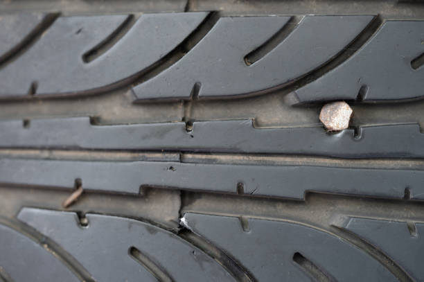 istock Damaged on spike car tyre 1415444583
