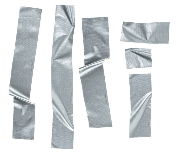 istock Pieces of silver self-adhesive construction tape isolated on a white background, top view. Metallic reinforced tape. 1415447183