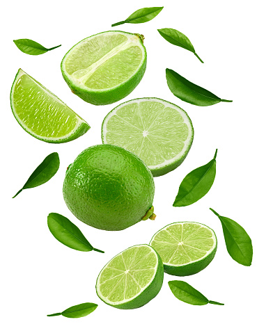 flying green limes with green leaves  isolated on white background. clipping path