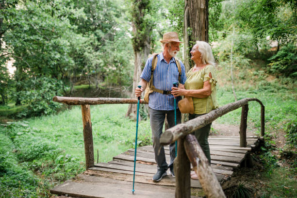Happy senior couple on hiking trip on summer holiday Happy senior couple on hiking trip on summer holiday aging population stock pictures, royalty-free photos & images