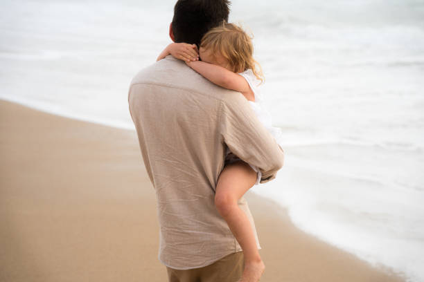 istock father holding his child 1415448979