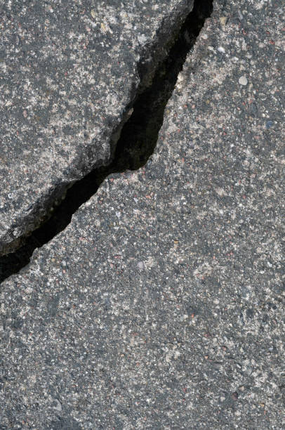 istock Old aged weathered cracked grey black tarmac texture pattern, large detailed damaged textured asphalt grungy background flat lay, vertical rough grained broken pattern macro closeup grunge copy space 1415449834