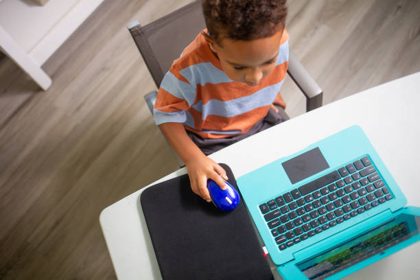 istock Top View Mixed 3 year Old Boy learning on the Laptop Computer 1415450805