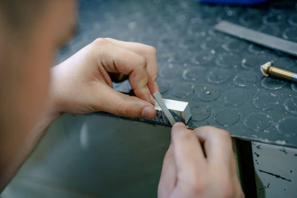 istock Industry worker sharpen metal parts 1415453471