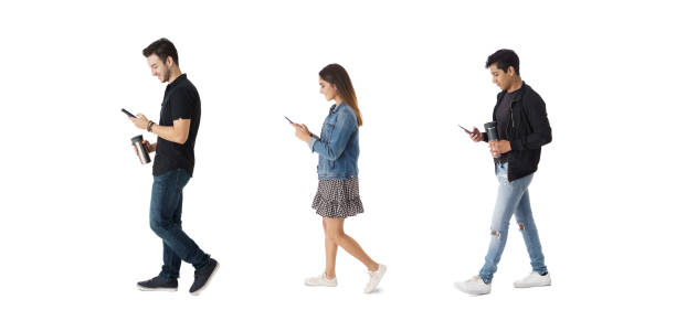 istock Three latin students walking and looking at phone 1415456680