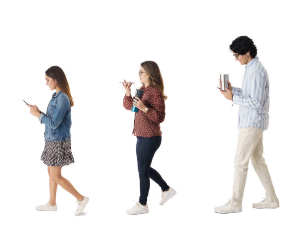 istock Three latin students walking and holding phones 1415456966