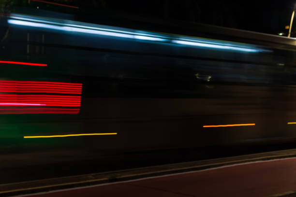 istock Colorful light trails with motion blur effect of a bus, long time exposure. 1415457719